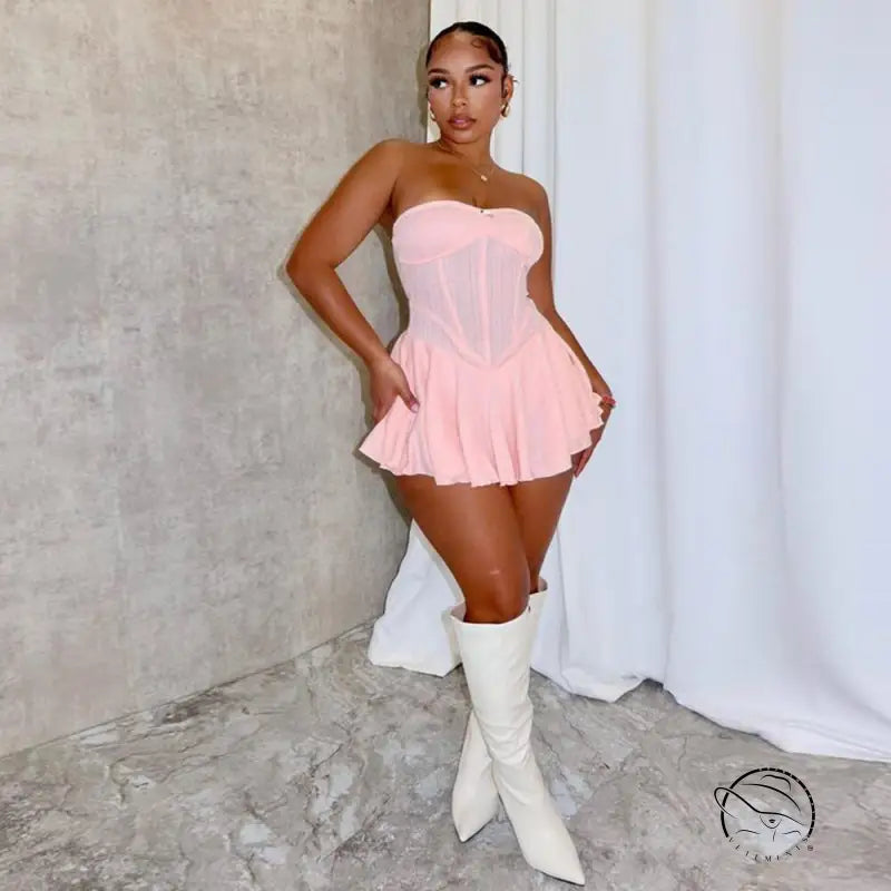 Woman in pink shoulder princess bodycon dress and white knee-high boots
