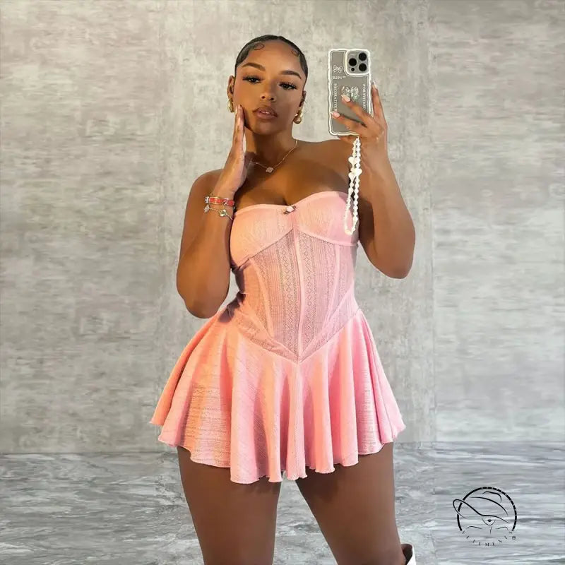 Woman in pink strapless shoulder princess dress taking mirror selfie