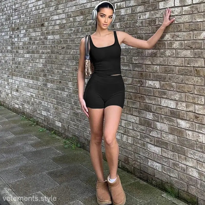 Woman in black athletic vest and slim shorts for summer shorts suit ensemble