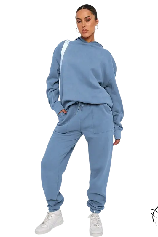 Woman in light blue soft touch trousers, warm comfortable long sleeve sweater, white sneakers