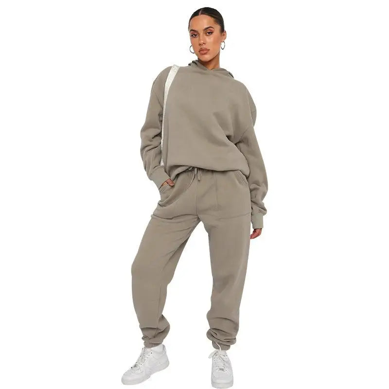 Woman in beige soft touch trousers and warm comfortable long sleeve sweater with white sneakers