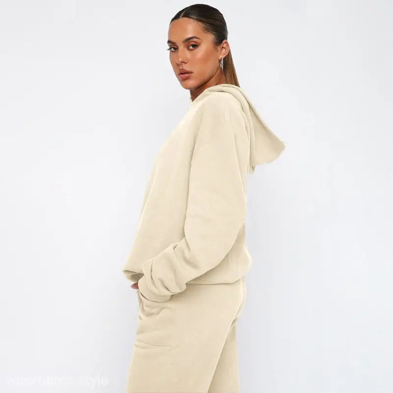 Woman wearing soft touch trousers and warm comfortable long sleeve sweater in cream
