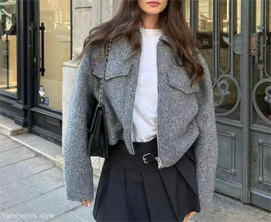 Gray wool cropped soft tweed jacket with winter polo collar over white top and black skirt