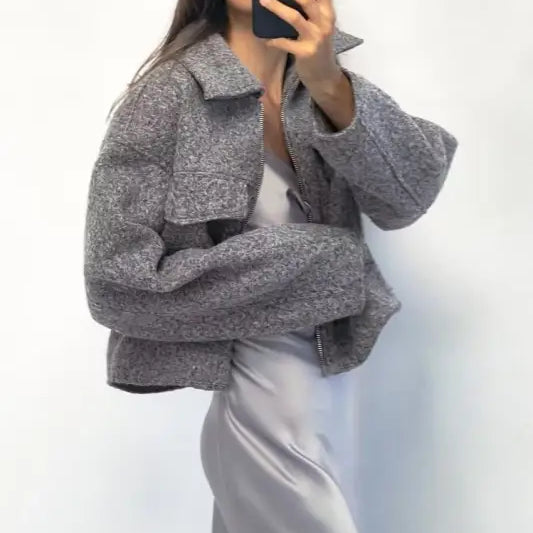 Gray textured oversized soft tweed jacket with winter polo collar over white dress or skirt