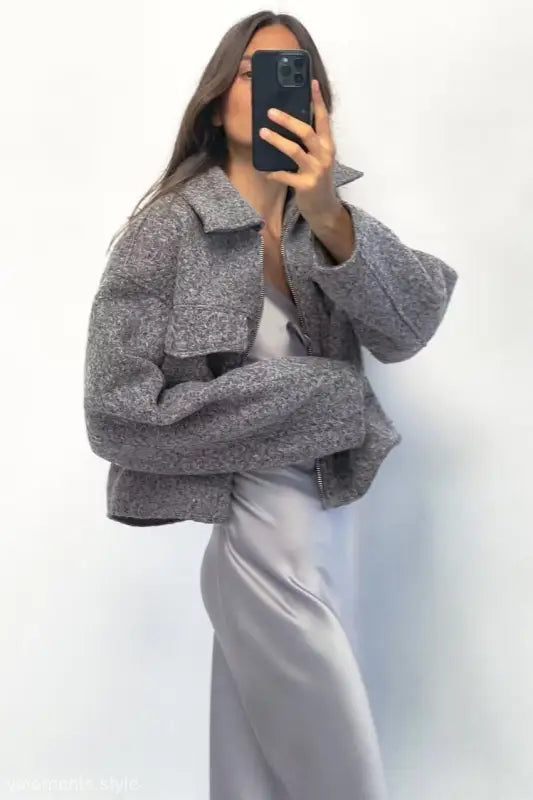 Gray textured oversized soft tweed jacket with winter polo collar over white dress or skirt