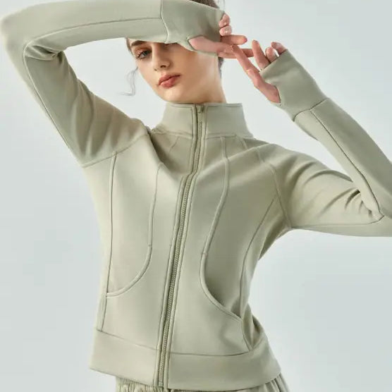 Pale green linen green air layer coat with Haiyan Ash accents worn with arms raised