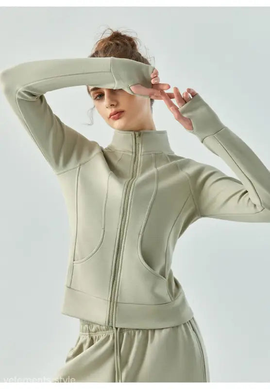 Pale green linen green air layer coat with Haiyan Ash accents worn with arms raised