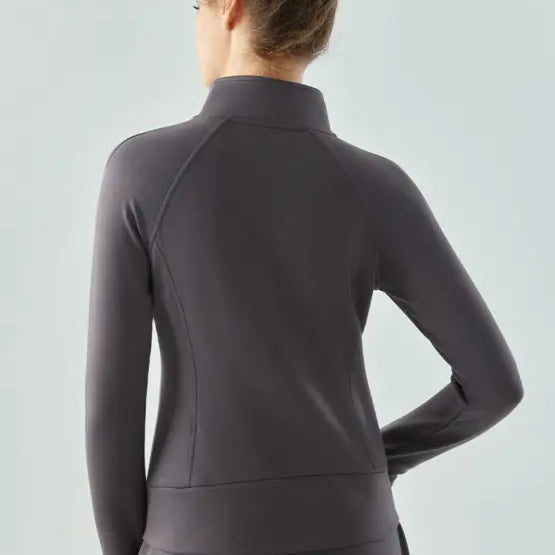 Gray athletic zip-up air layer coat in Haiyan Ash worn by a person with a bun