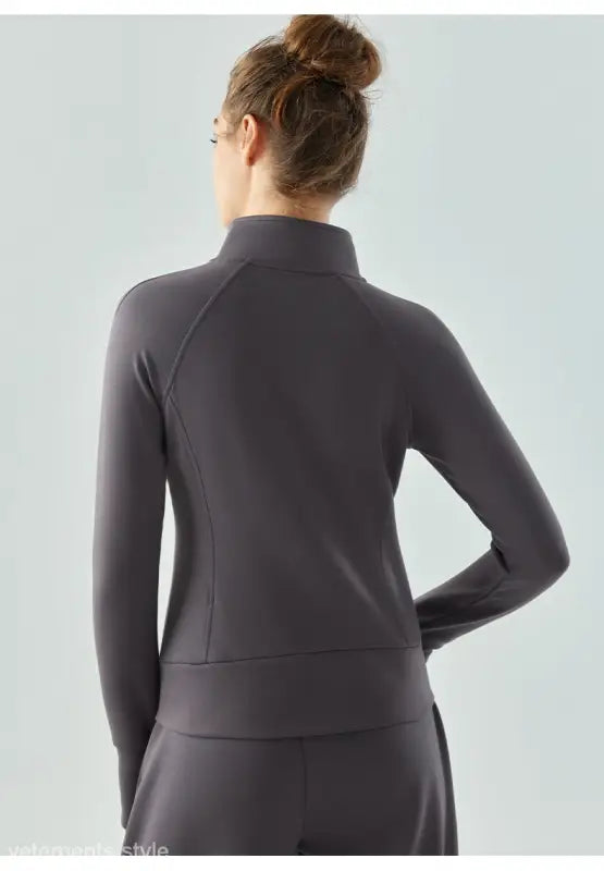 Gray athletic zip-up air layer coat in Haiyan Ash worn by a person with a bun