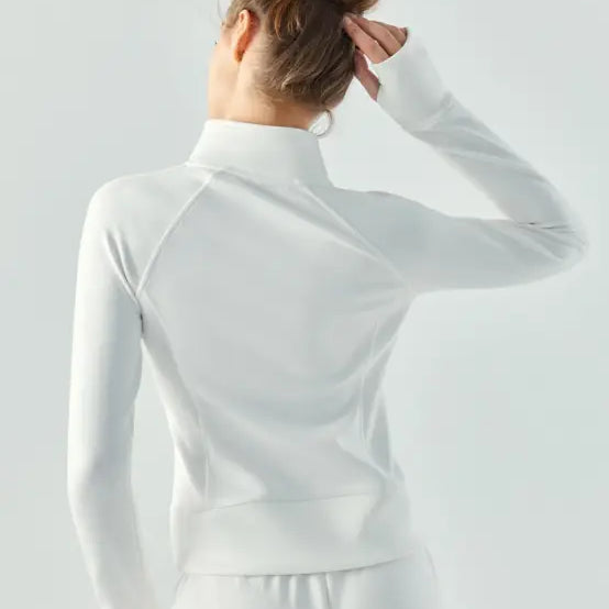 Woman wearing a white long-sleeved top with her hair in a bun, viewed from behind, showcasing the Sporty Air Layer Coat in Linen Green and Haiyan Ash for Spring/Fall