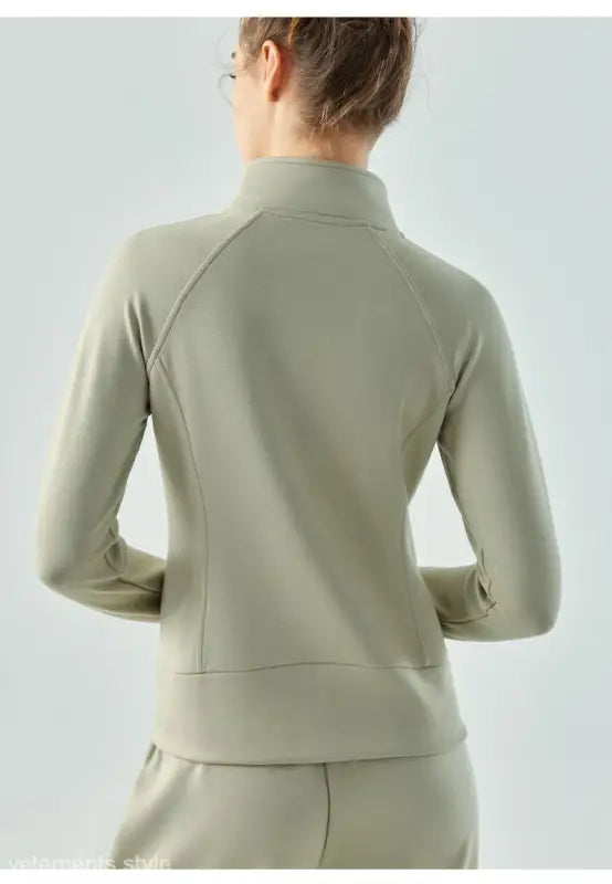 Light beige zip-up athletic air layer coat in Linen Green and Haiyan Ash from behind