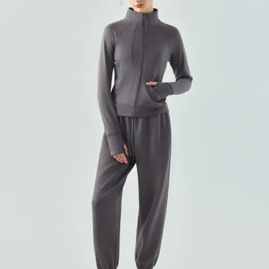 Gray athletic tracksuit with zip-up jacket and jogger pants, ideal as an air layer coat in Haiyan Ash and Linen Green