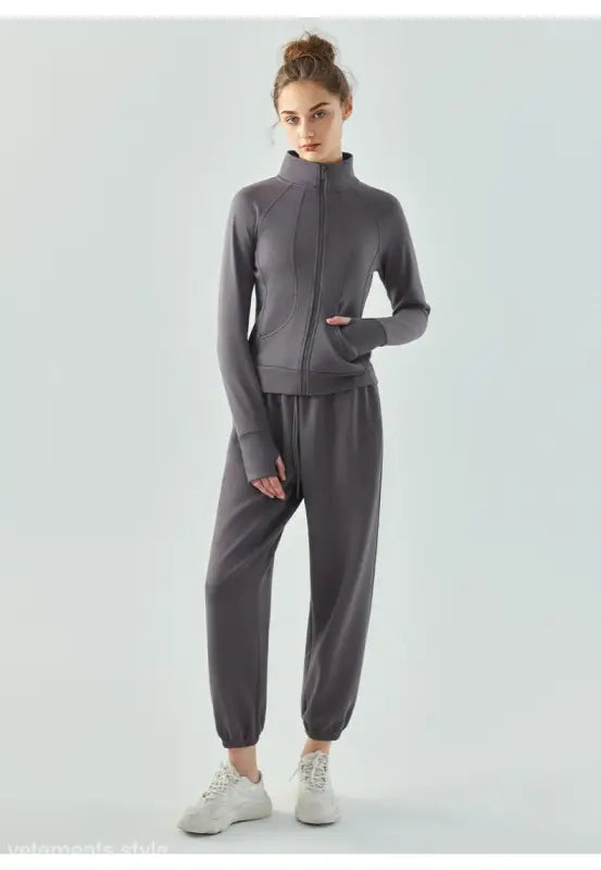 Gray athletic tracksuit with zip-up jacket and jogger pants, ideal as an air layer coat in Haiyan Ash and Linen Green