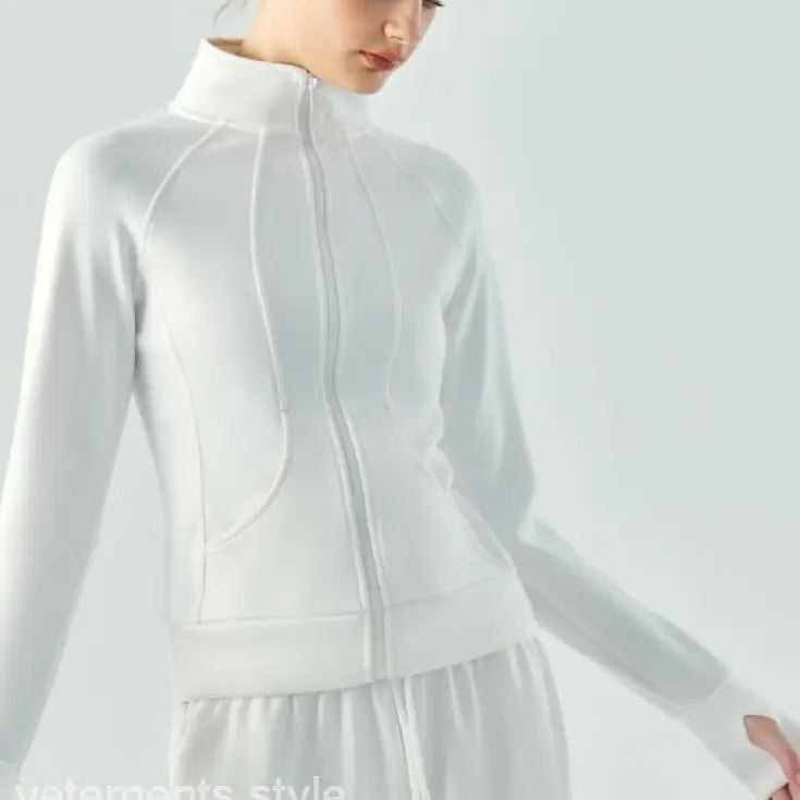 White zip-up athletic jacket with high collar and fitted silhouette in linen green and Haiyan Ash for spring fall