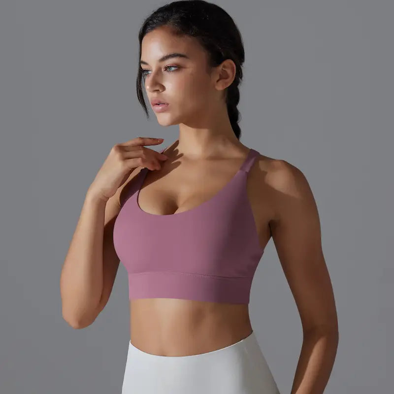 Purple sports bra worn by a woman, showcasing the Sporty Backless Yoga Vest with Cutout Back