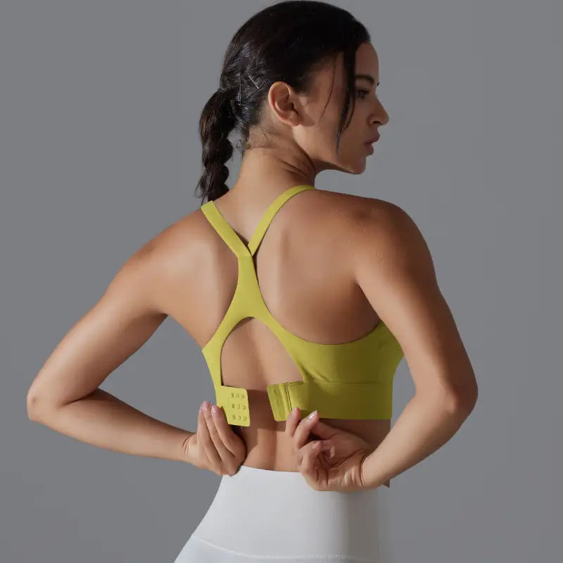 Yellow sports bra with racerback and adjustable closure, part of the backless yoga vest collection