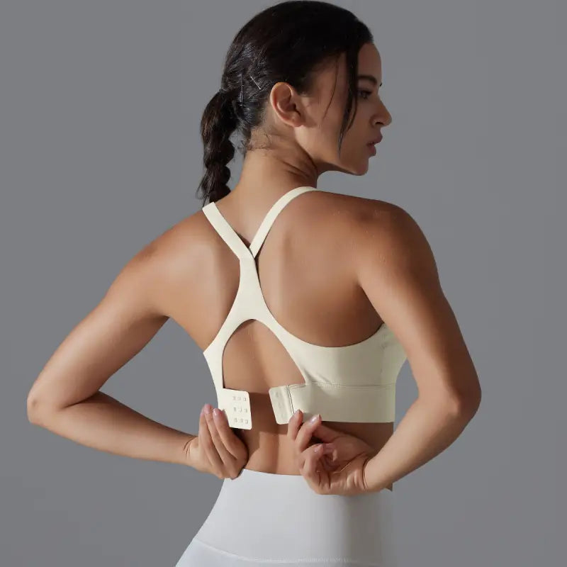 Backless yoga vest with racerback design, adjustable hook closure, and cutout back