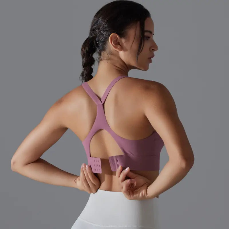 Purple sports bra with racerback design and adjustable hook closure for backless yoga vest