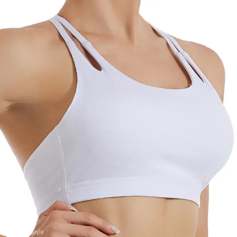 White sports bra with double shoulder straps, perfect for outfits in Hydrangea Purple and Emerald Green