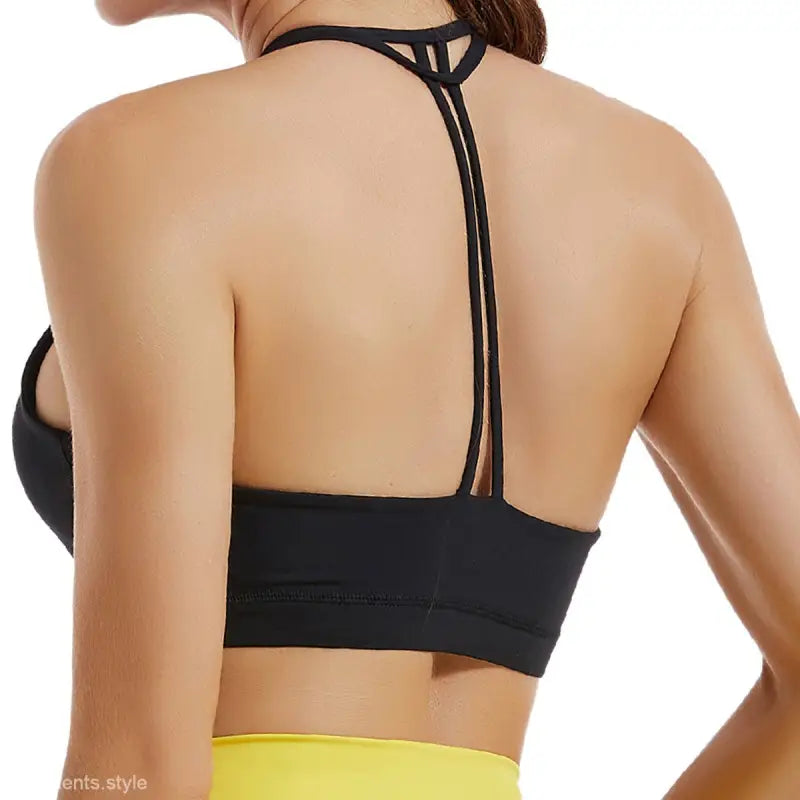 Black Sports Bra with T-back design, featuring Hydrangea Purple and Emerald Green accents
