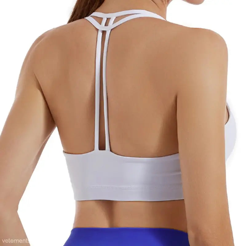 White sports bra with strappy back design in Hydrangea Purple and Emerald Green
