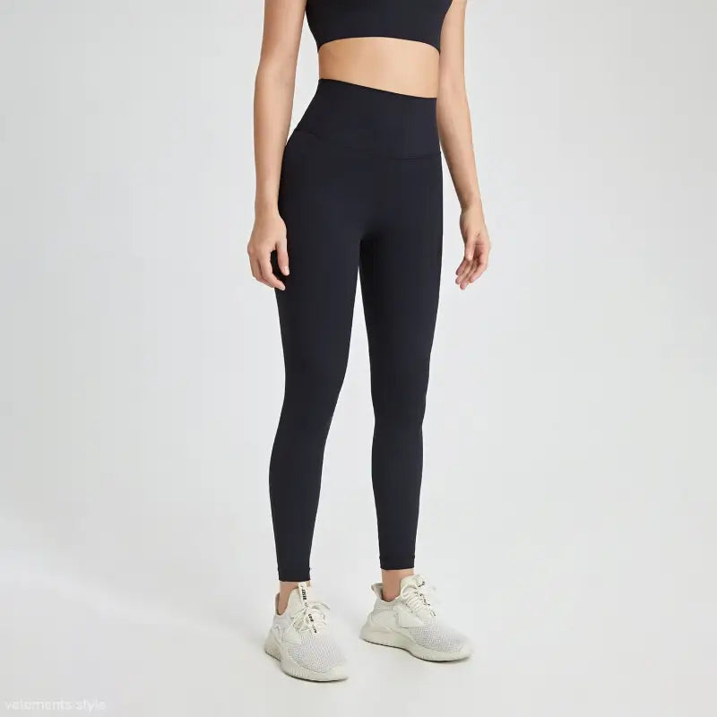 Sporty high rise nylon pants in wild berry color with black leggings and white sneakers