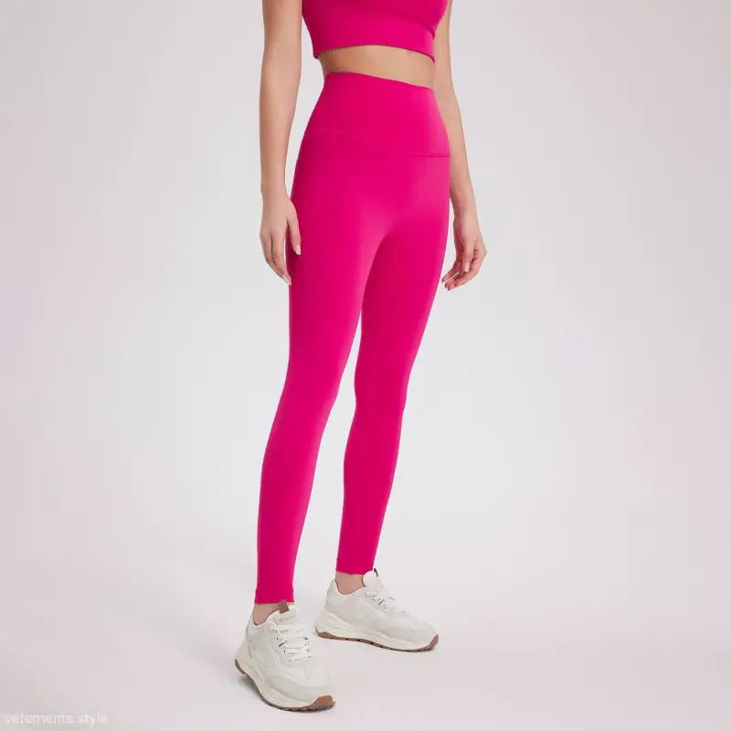 Neon pink high-rise wild berry leggings with white sneakers