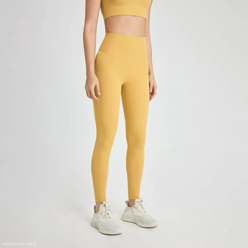 High-waist mustard yellow leggings in wild berry color with white sneakers