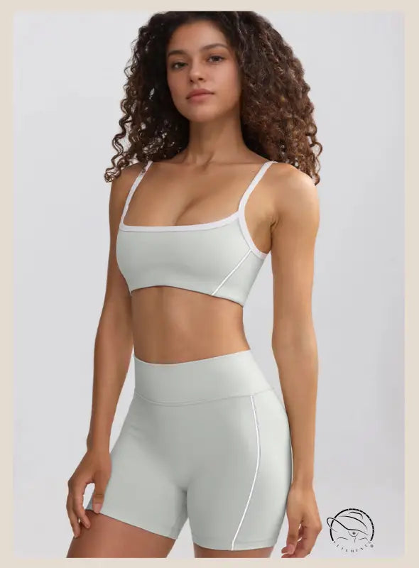 Woman in white sports bra and high-waisted summer yoga shorts