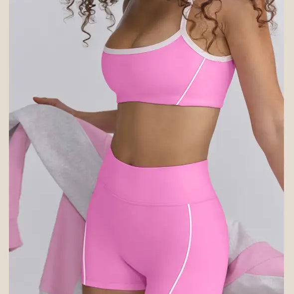 Bright pink workout set consisting of a sports bra and high-waisted shorts.