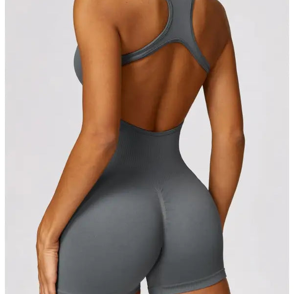 Gray athletic bodysuit styled as a yoga bodysuit paired with Volcanic Ash shorts