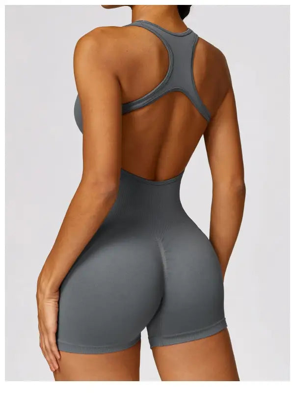 Gray athletic bodysuit styled as a yoga bodysuit paired with Volcanic Ash shorts