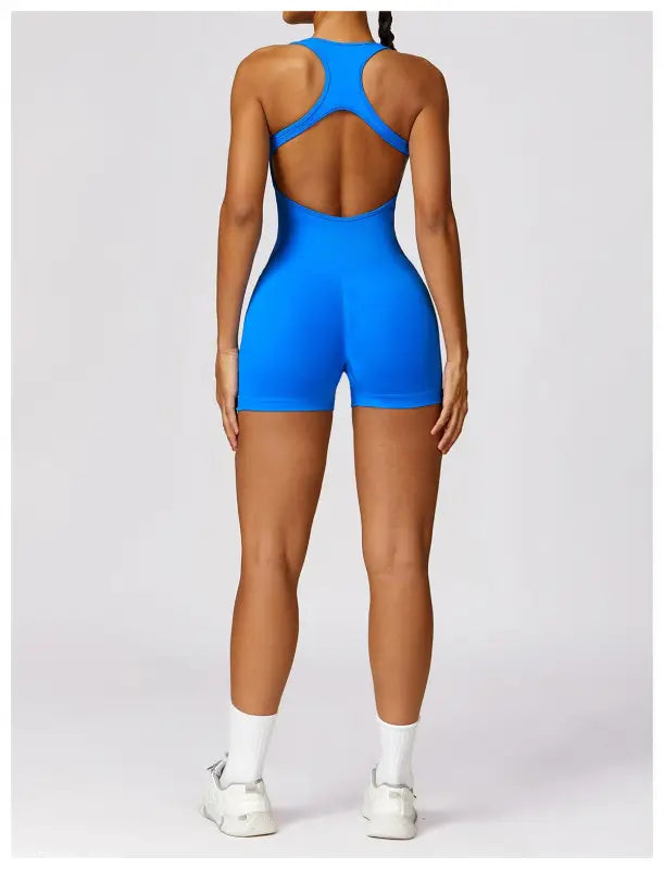 Blue athletic romper in Yoga bodysuit style, paired with Volcanic Ash high rise shorts