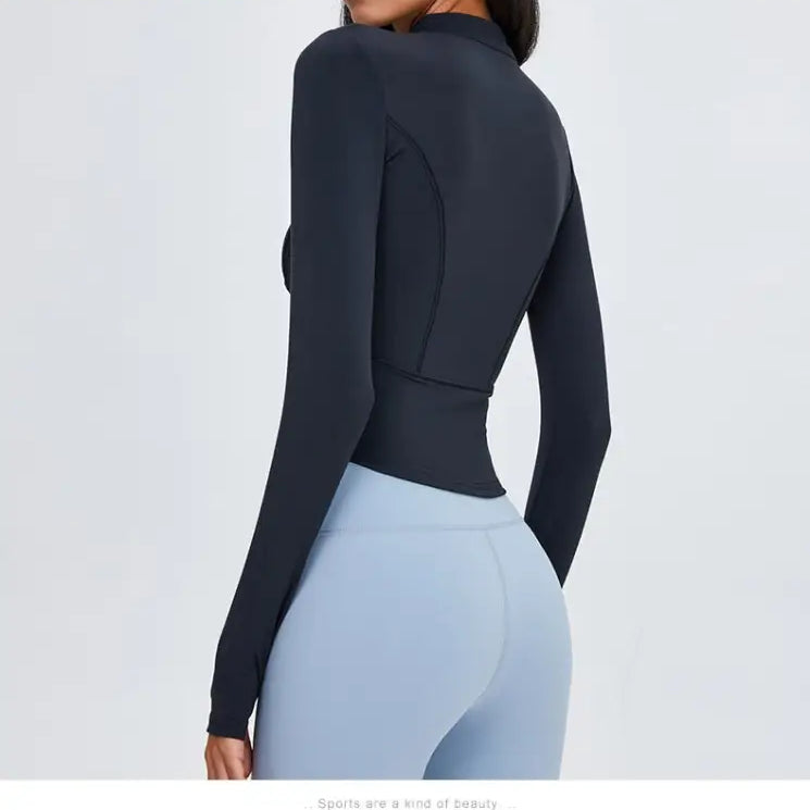 Sporty long sleeve nylon tee in Phantom Black with light blue leggings for active wear