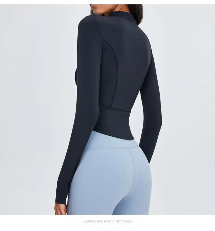 Sporty long sleeve nylon tee in Phantom Black with light blue leggings for active wear