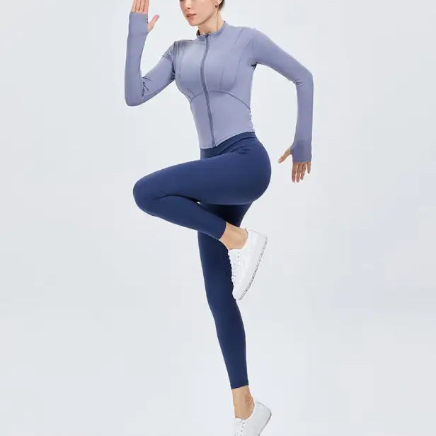 Woman in athletic wear wearing Sporty Long Sleeve Nylon Tee in Phantom Black or Dark Gray Purple