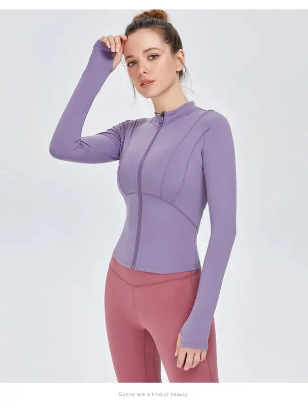 Woman in purple athletic jacket and pink leggings wearing Sporty Long Sleeve Nylon Tee Phantom Black or Dark Gray Purple