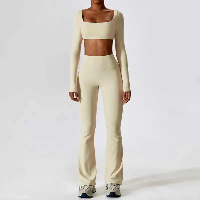 Cream-colored two-piece workout set featuring long sleeve trousers in camel brown and bean green