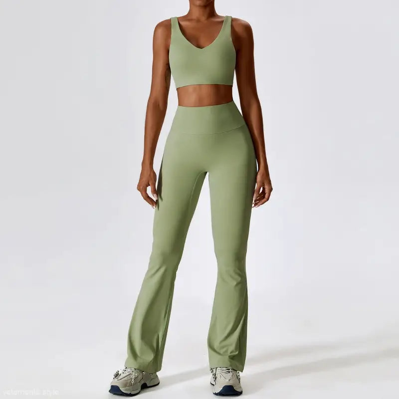 Sage green workout set with sports bra and flared yoga pants styled with long sleeve trousers