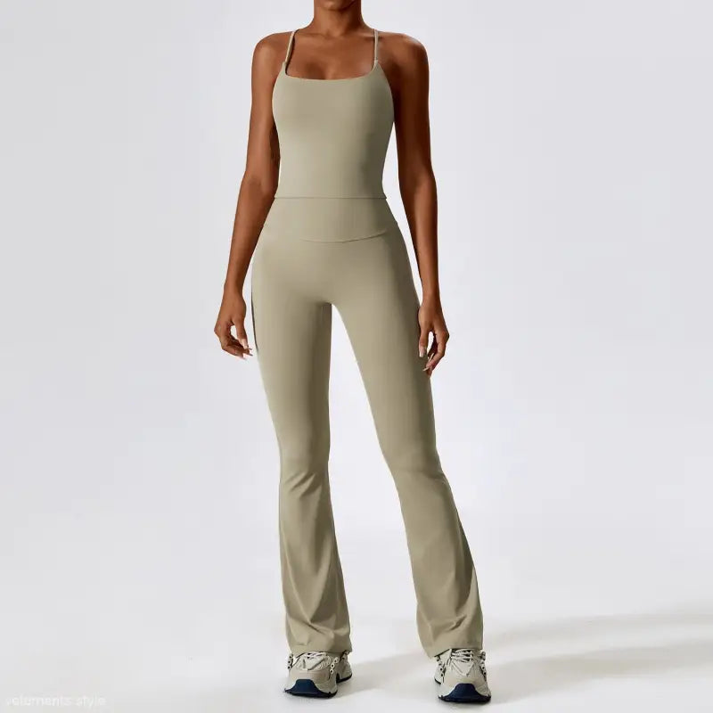 Sage green sleeveless jumpsuit with flared legs, styled with Camel Brown and Bean Green trousers