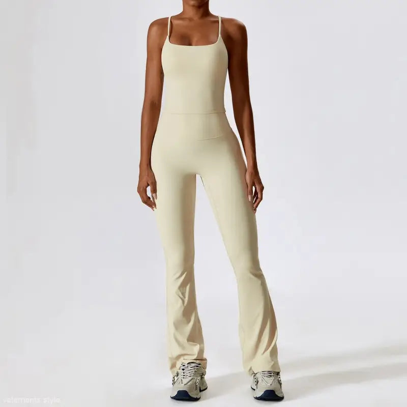 Cream-colored sleeveless jumpsuit with flared legs, enhancing long sleeve trousers style