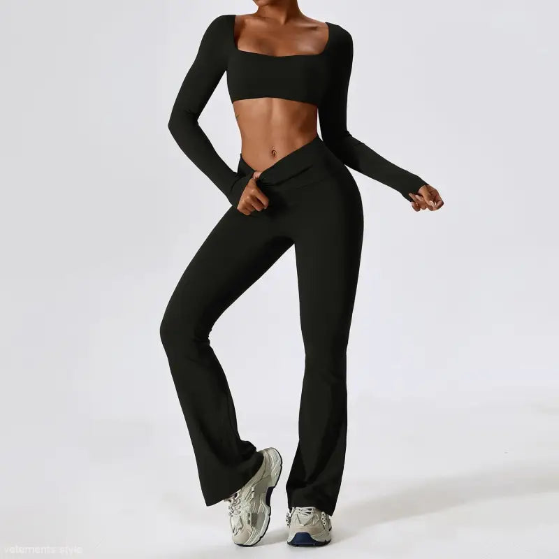 Black long-sleeved crop top and flared yoga pants set with white sneakers for activewear