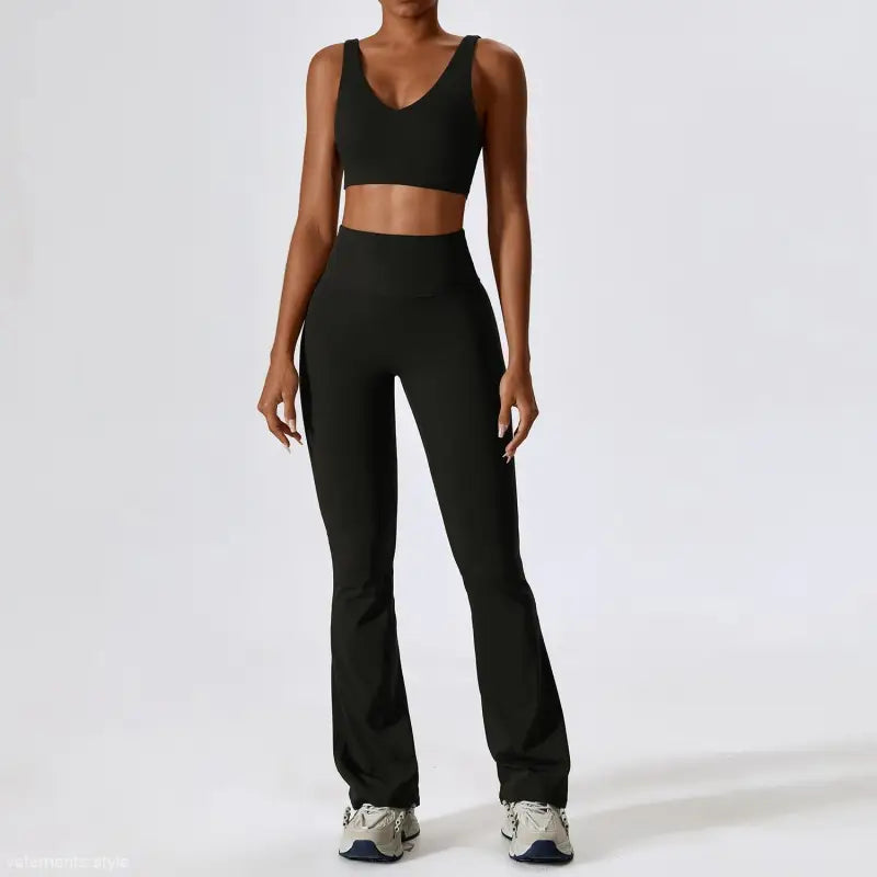 Black workout set featuring a sports bra and flared yoga pants alongside trousers camel brown