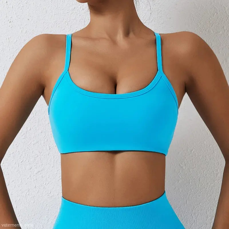 Bright turquoise sports bra with thin straps from Sporty Nylon Cutout Back Strap in advanced black and fluorescent orange