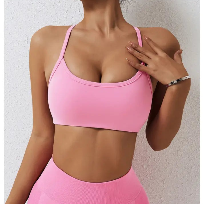 Pink sports bra with thin straps from Sporty Nylon Cutout Back Strap in Advanced Black and Fluorescent Orange