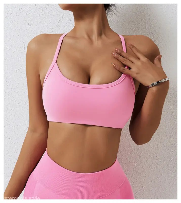 Pink sports bra with thin straps from Sporty Nylon Cutout Back Strap in Advanced Black and Fluorescent Orange