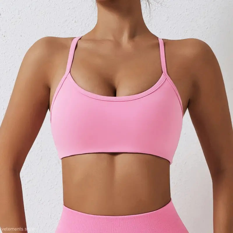 Pink sports bra with thin straps and scoop neckline from Sporty Nylon Cutout Back Strap in advanced black and fluorescent orange