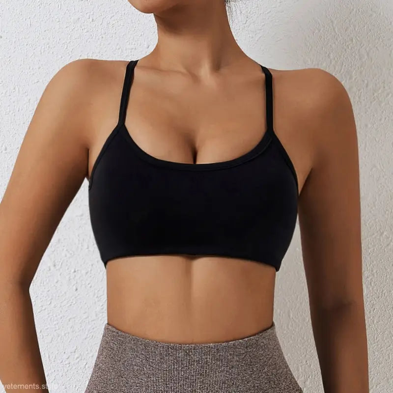 Black sports bra with thin straps and scoop neckline from Sporty Nylon Cutout Back Strap in advanced black and fluorescent orange