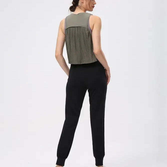 Woman wearing a sleeveless Chinese olive green half waist blouse and black pants