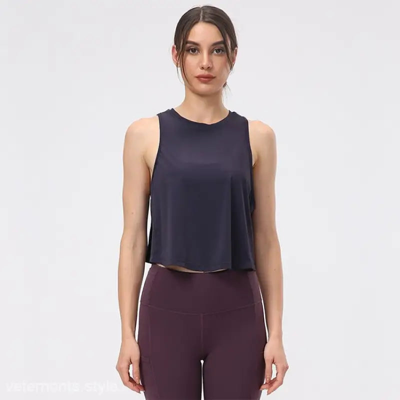Woman in navy sleeveless top and burgundy leggings showcasing Chinese Olive Green half waist blouse in Midnight Blue